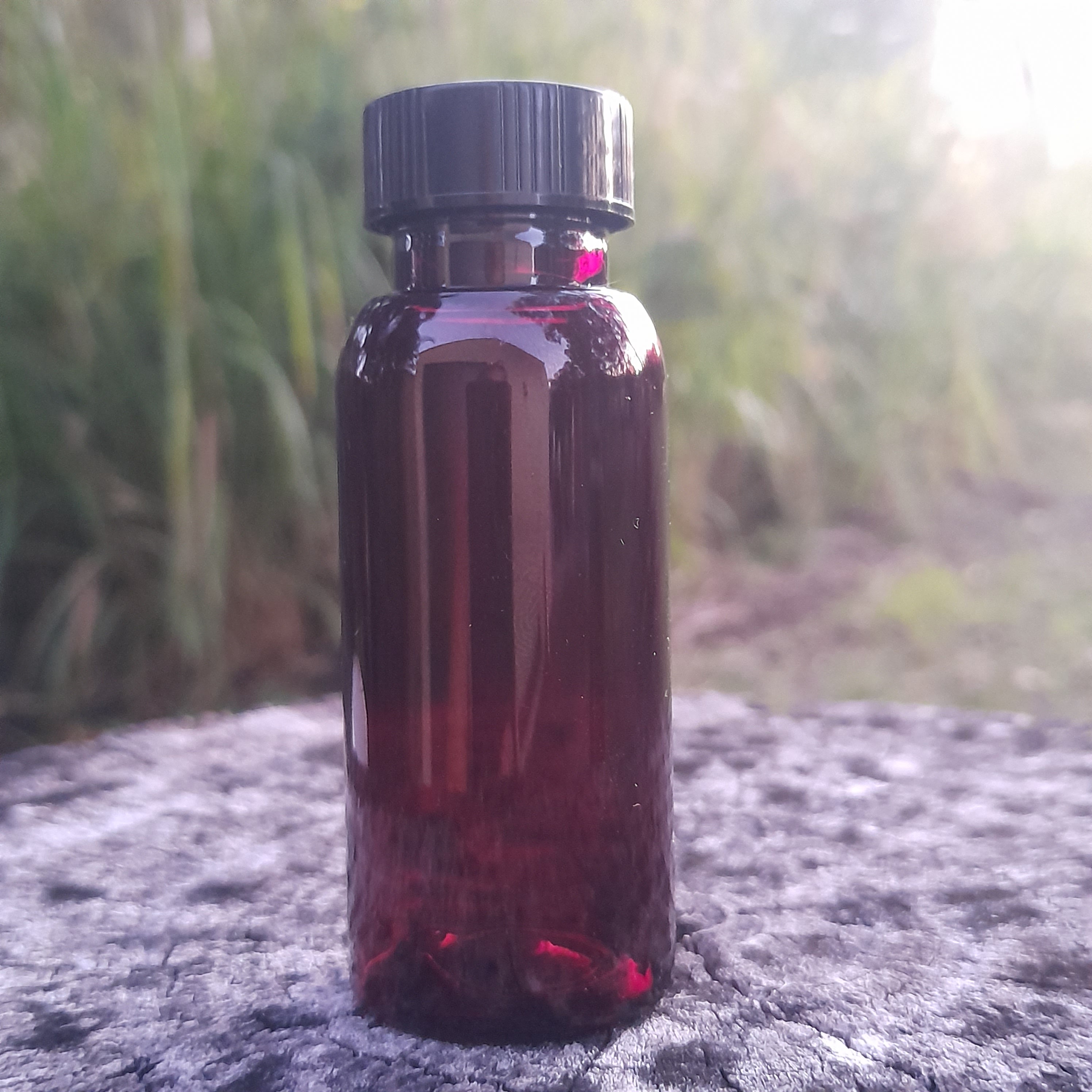 Empty amber PET 50ml travel bottle with plain black cap 24mm neck